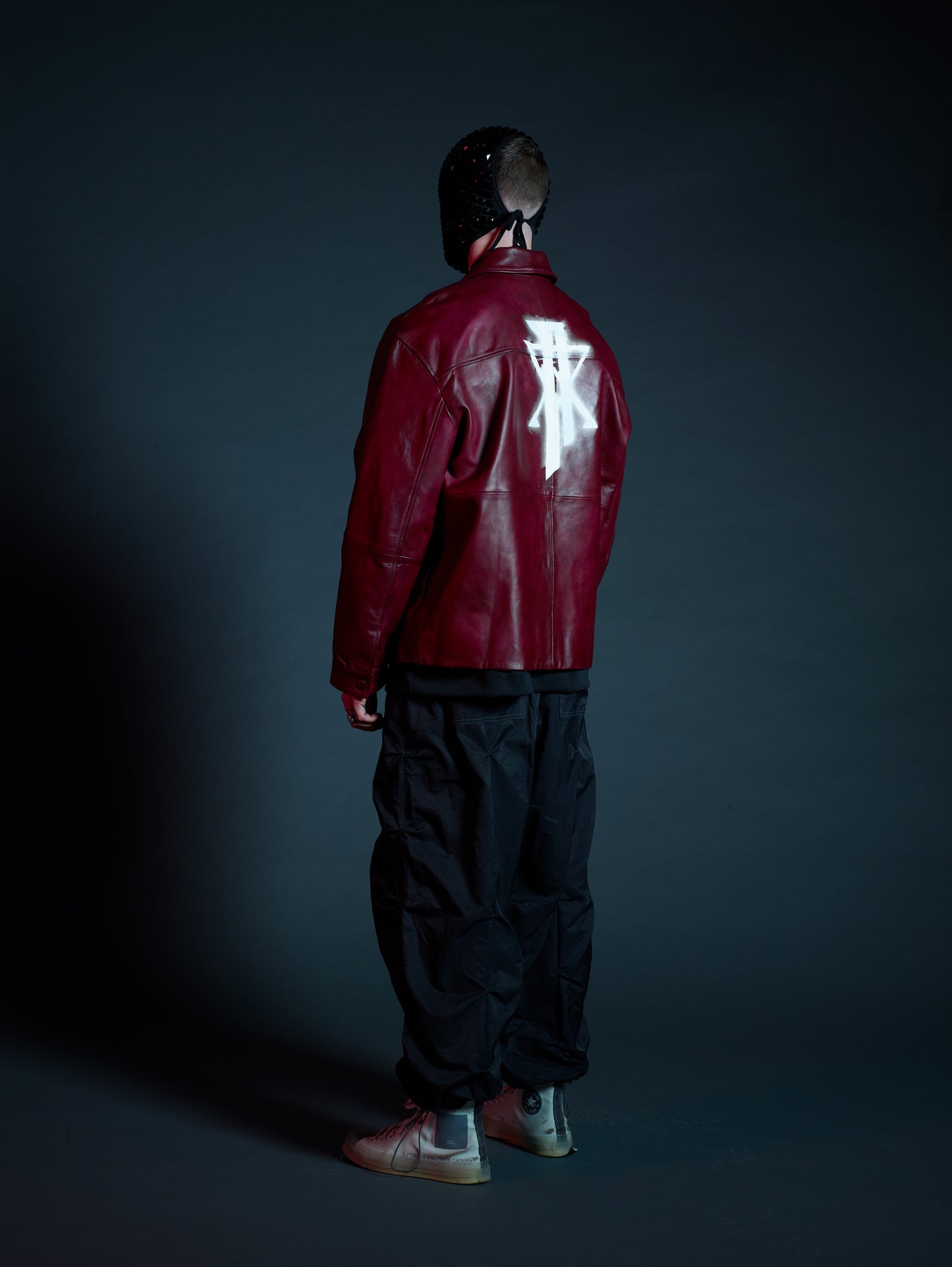 Model styling Kamikaze streetwear jacket with black cargos for a bold look
