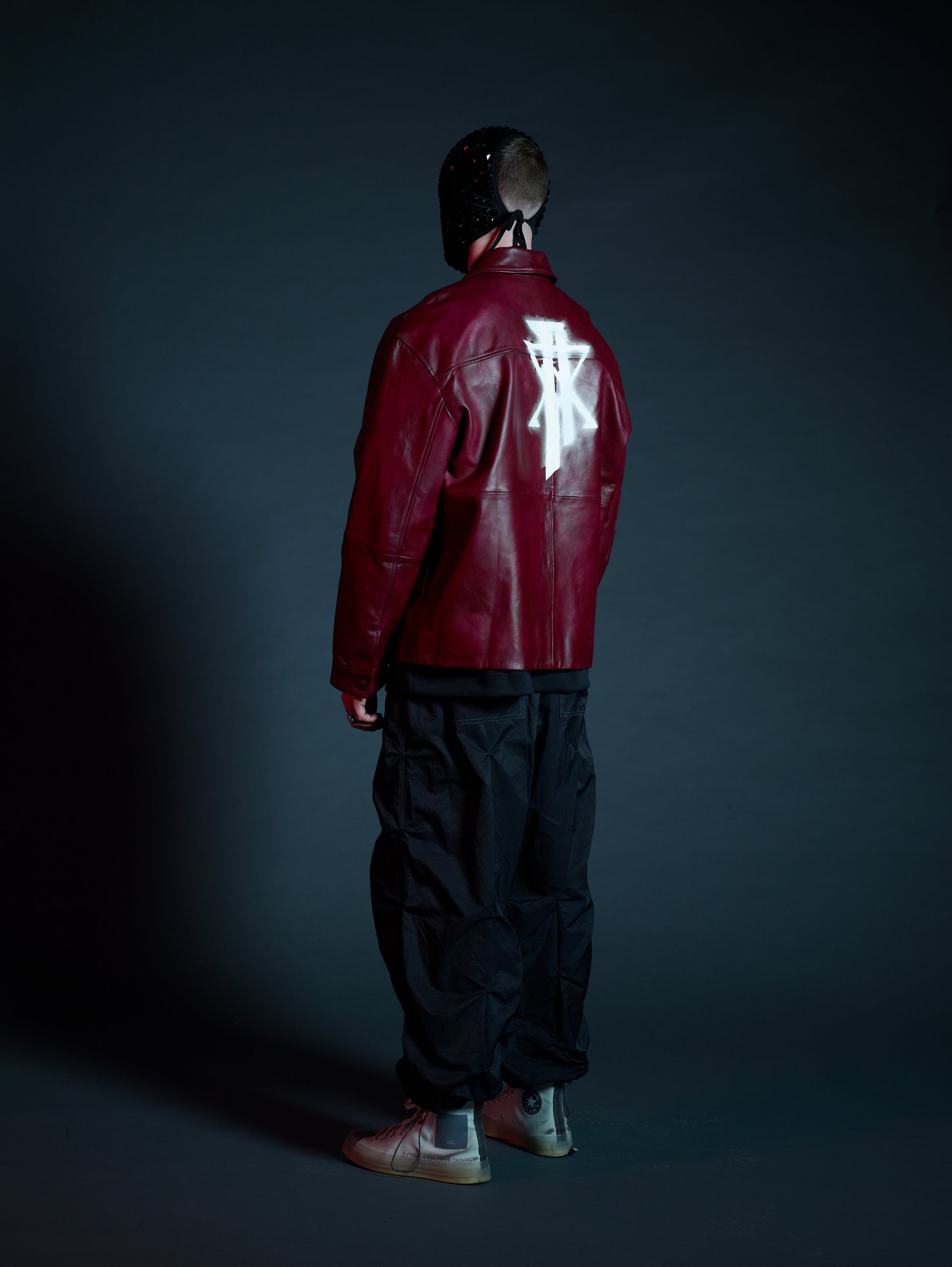 Model styling Kamikaze streetwear jacket with black cargos for a bold look