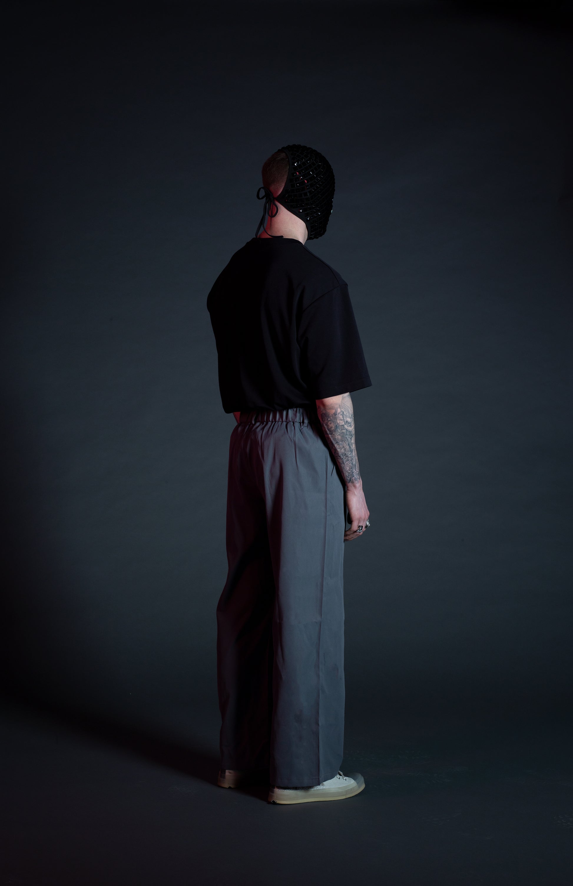 Back view of men’s wide leg trousers with elevated pleated design