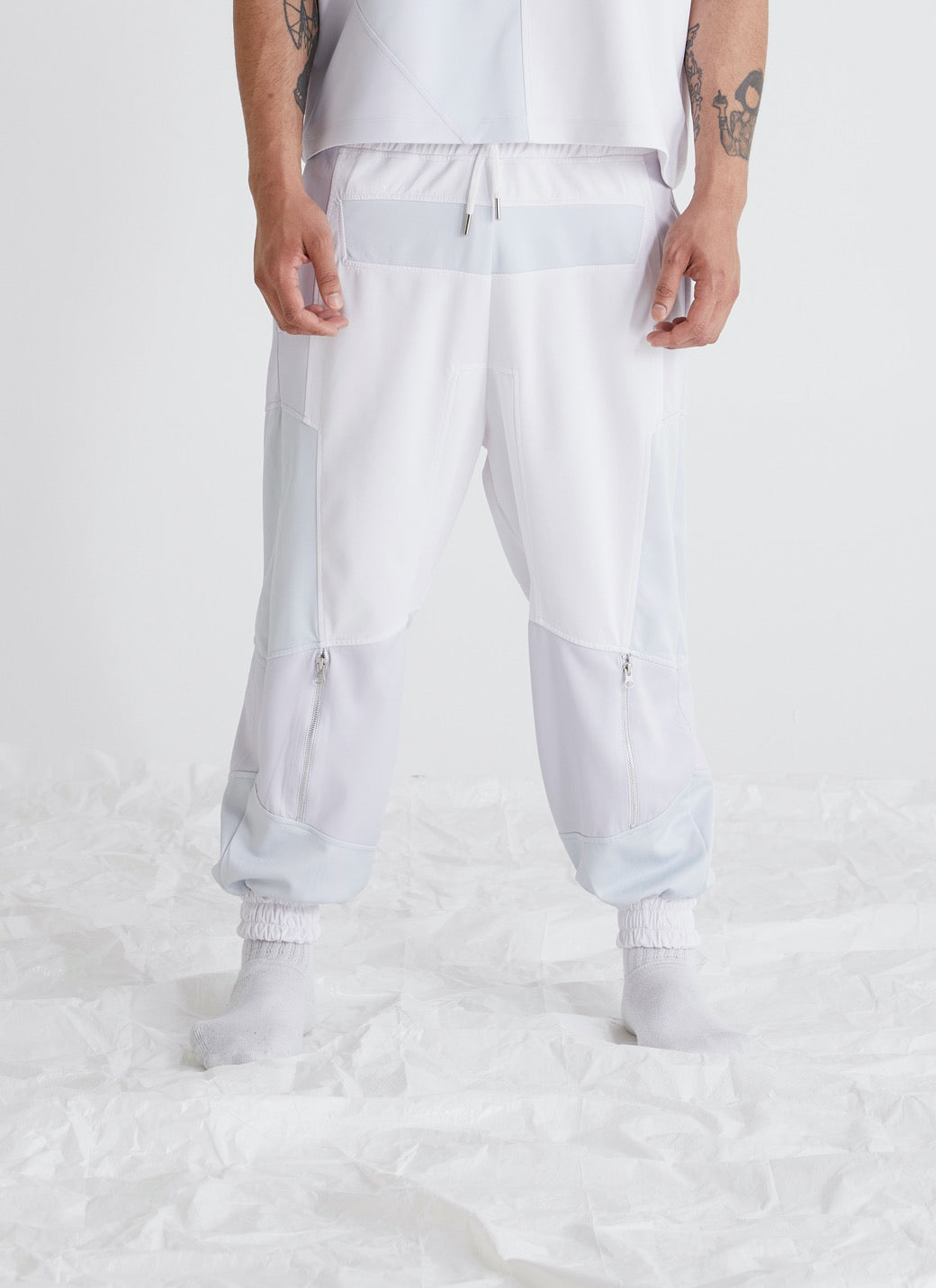 Oasis colour block mens sweatpants front view, premium scuba fabric, elevated drawcord waistband with metal tips, metal zipper styling near hem, modern menswear.