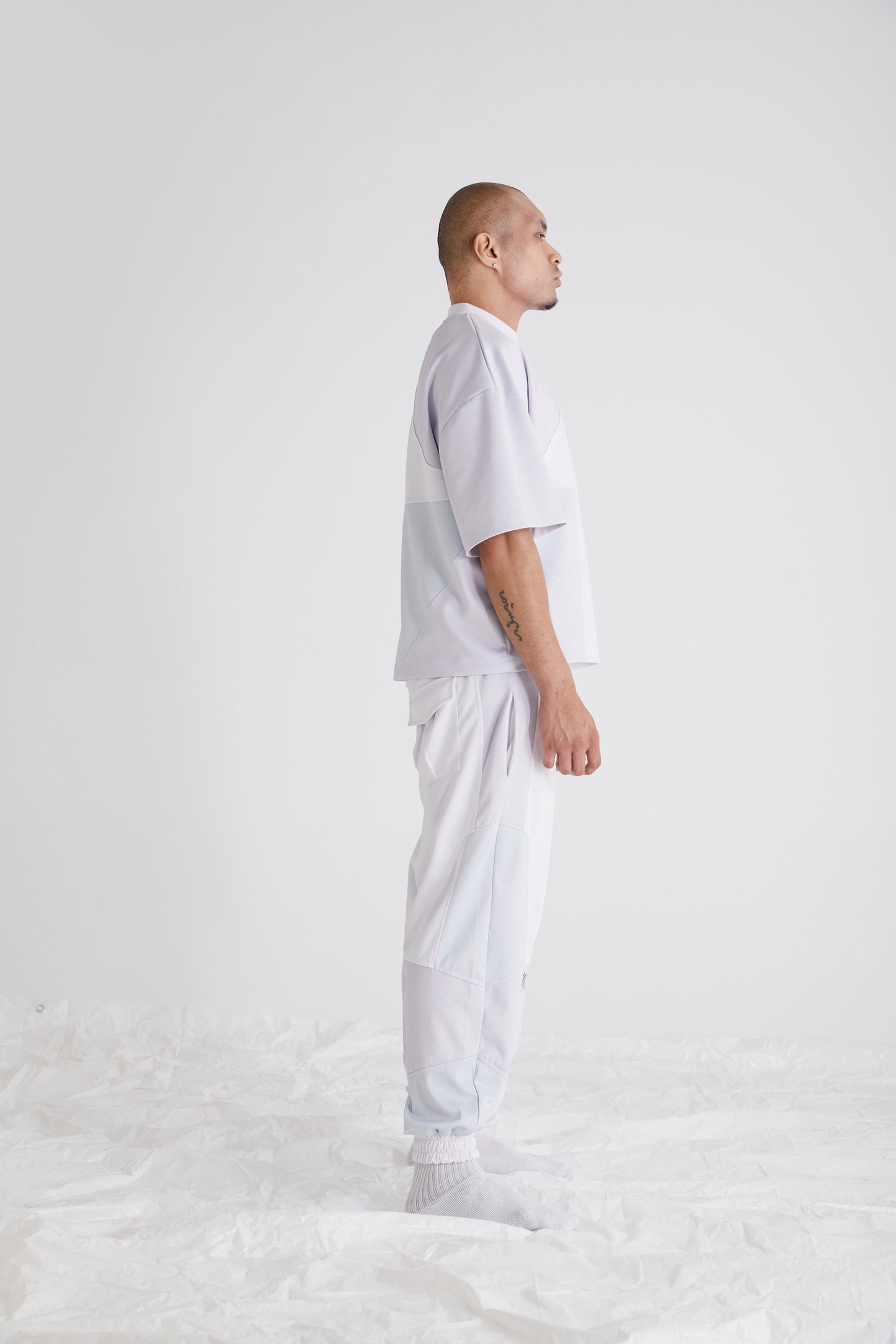 Side view showing metal zipper hem on mens streetwear pants