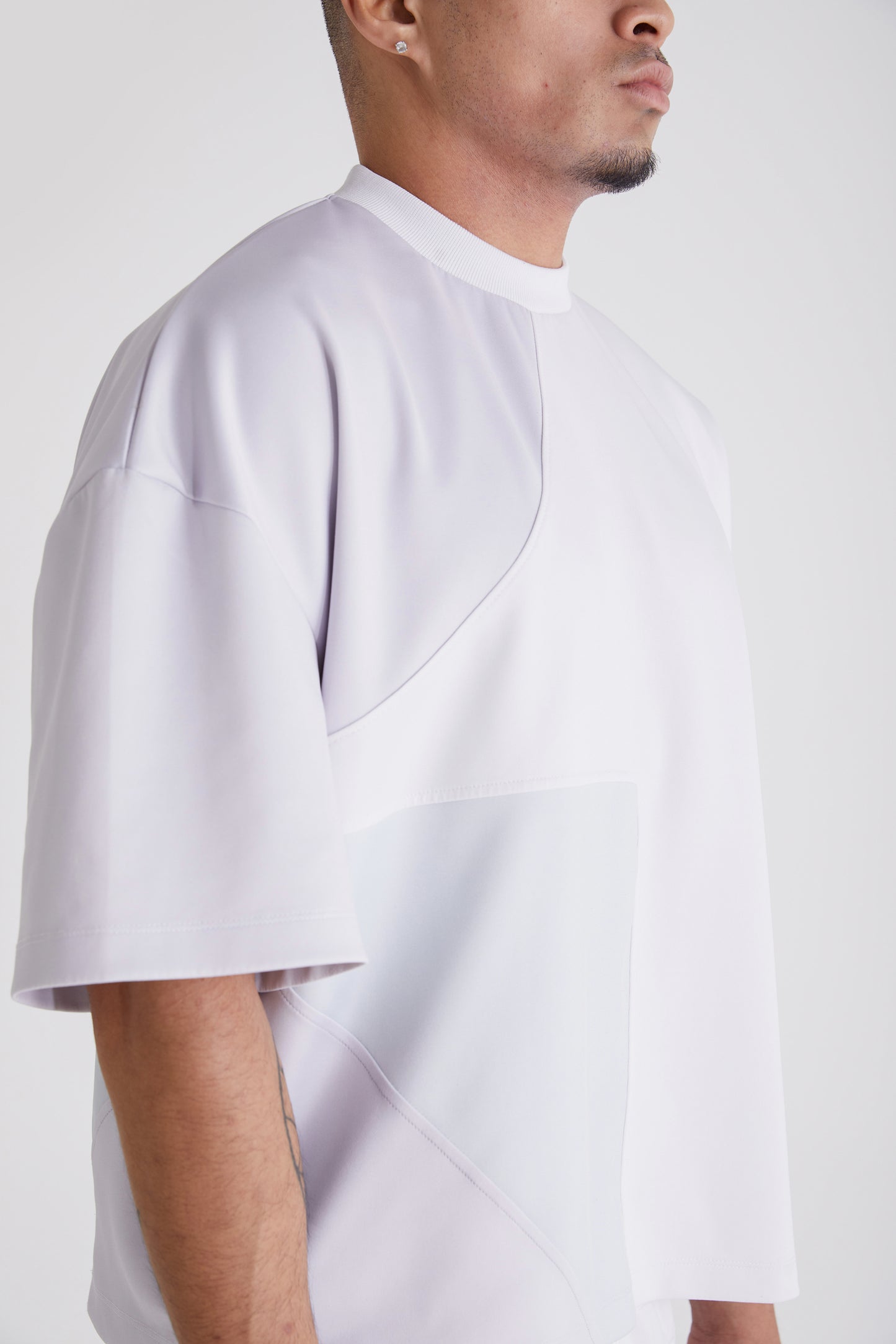 Close-up of ribbed neckline and colour block detailing on Nouvel streetwear tee