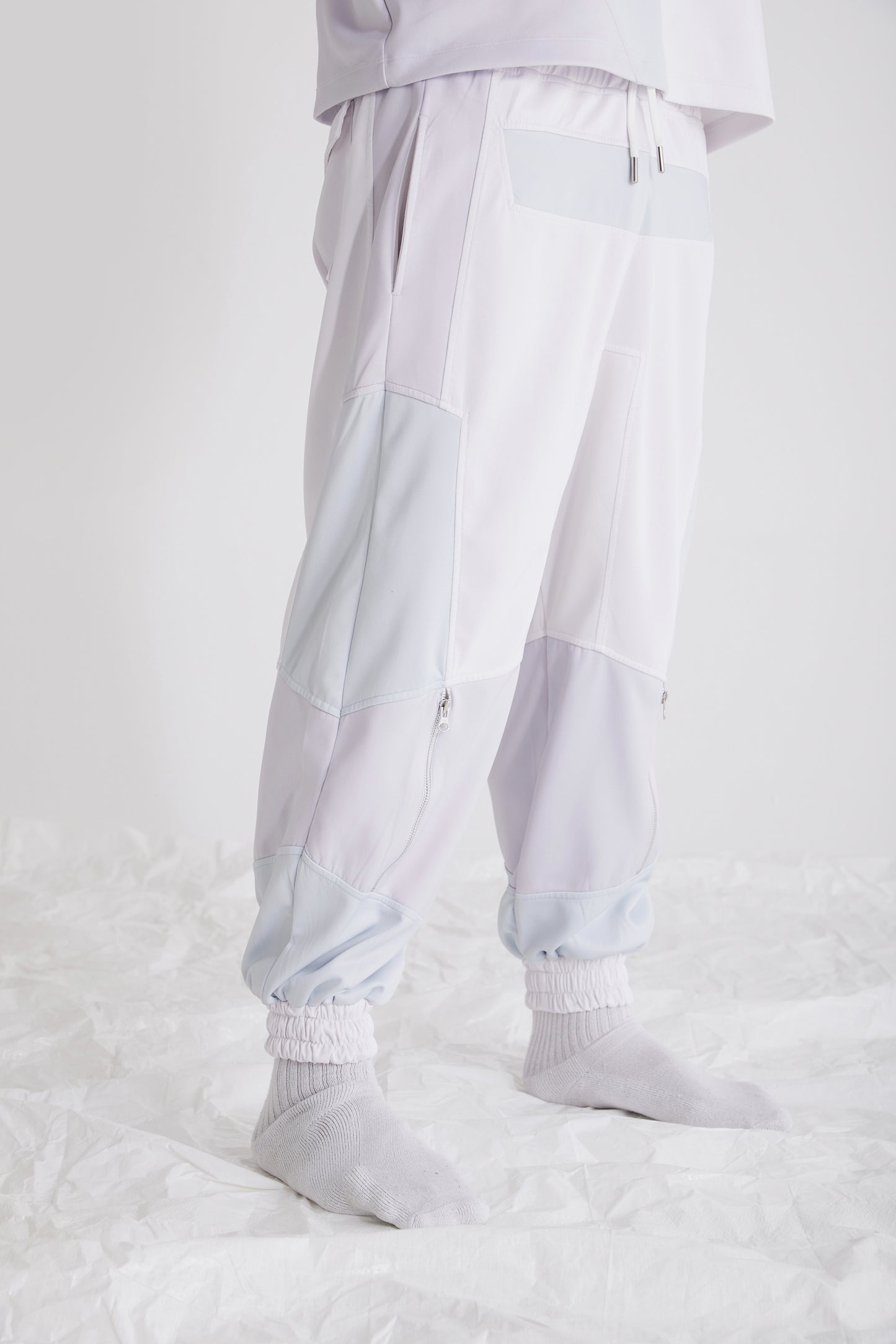 Side view showing metal zipper hem on mens streetwear pants