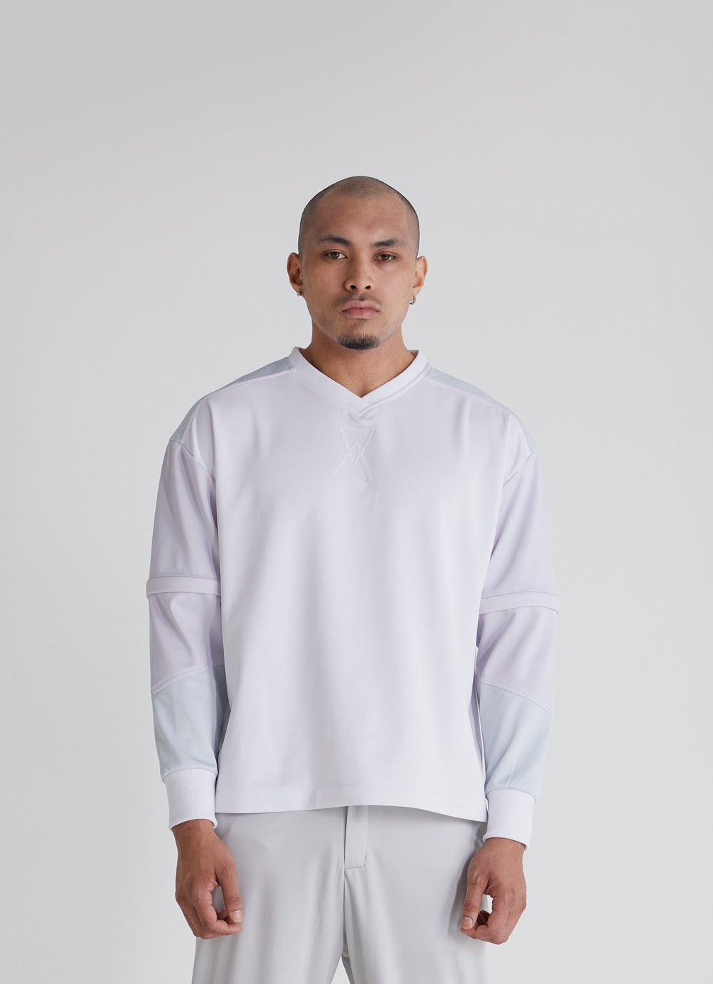 Model removing sleeves on Ascension mens streetwear sweatshirt