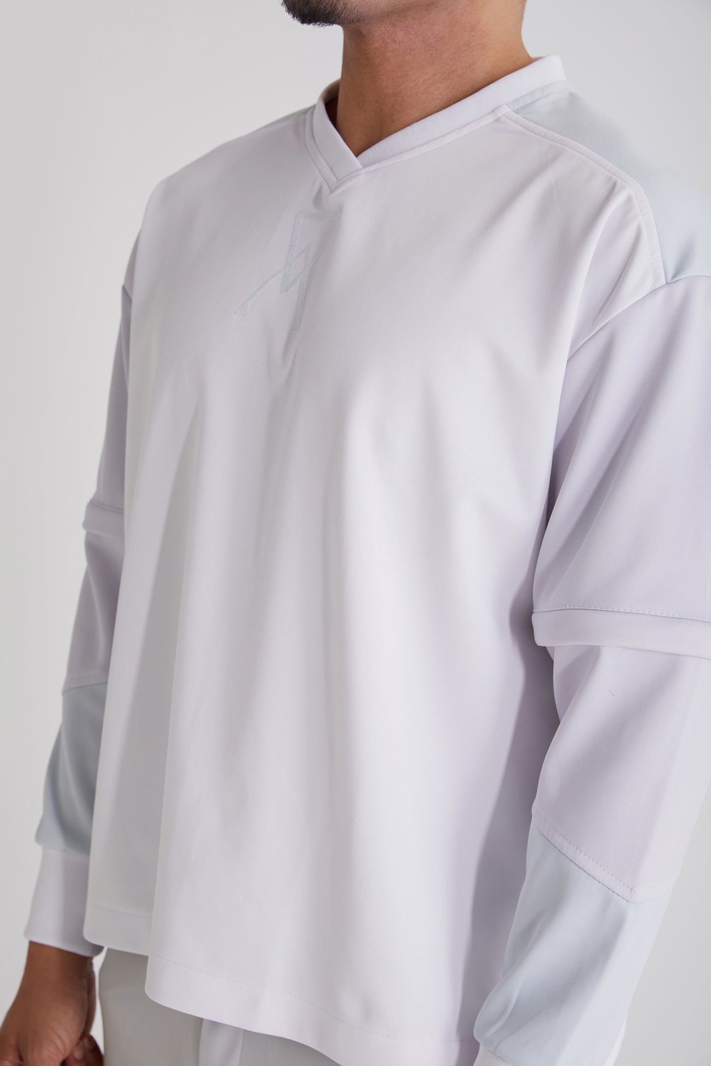 Close-up of metal zipper detailing on removable sleeves of Ascension sweatshirt